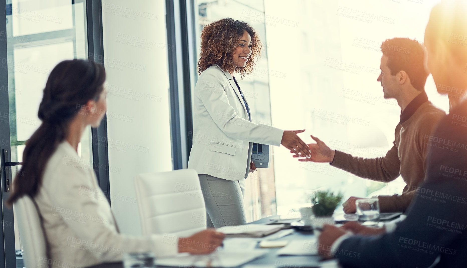 Buy stock photo Cropped shot of businesspeople shaking hands during a meeting in an office