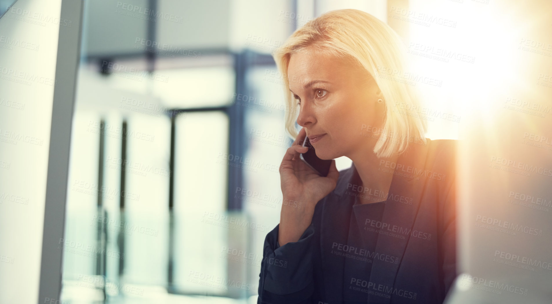 Buy stock photo Shot of a professional businesswoman using a computer and phone at work