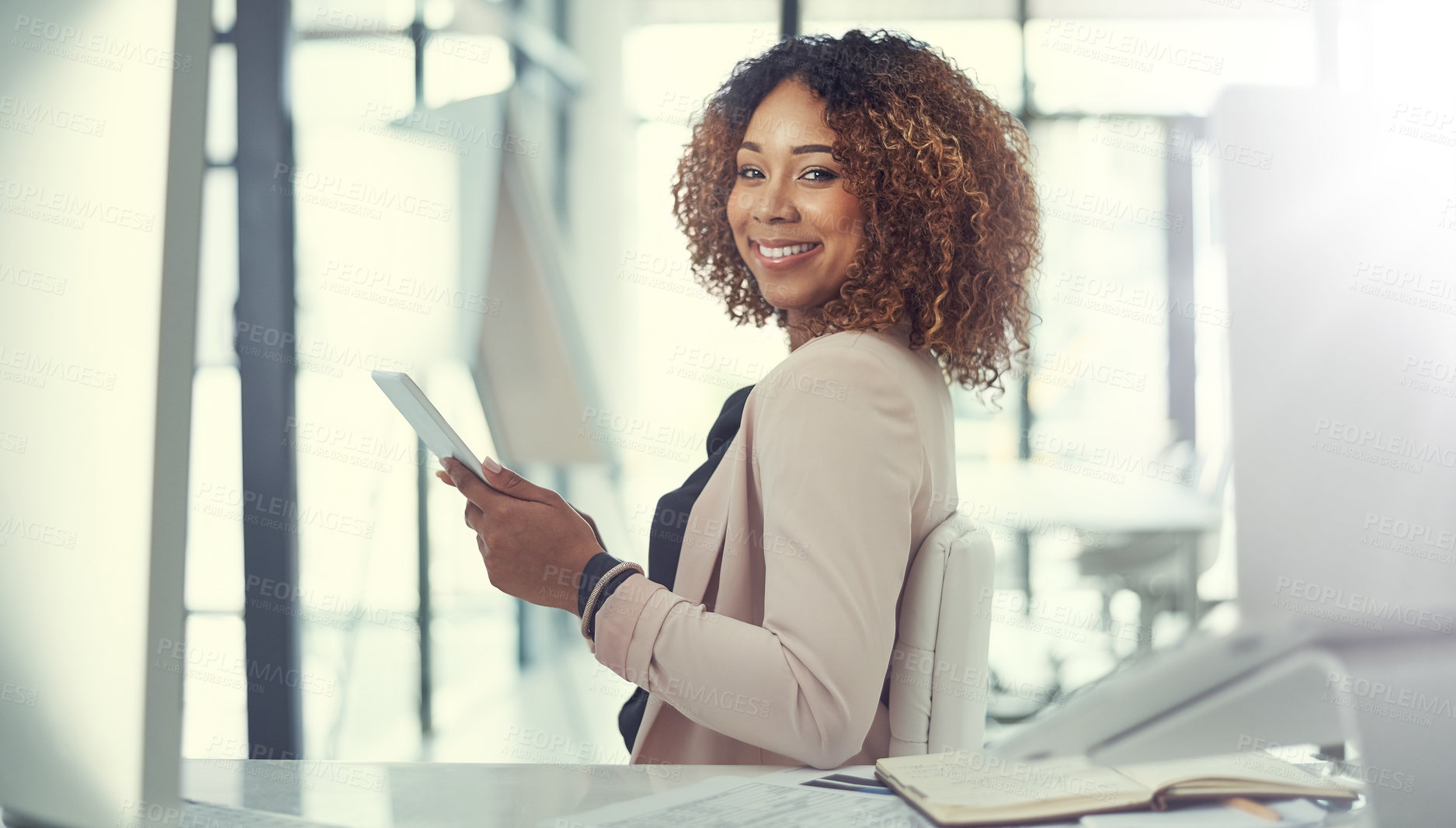 Buy stock photo Shot of a young businesswoman using a digital tablet at work