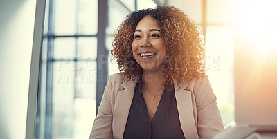 Buy stock photo Shot of a thoughtful young businesswoman working at her desk in a modern office