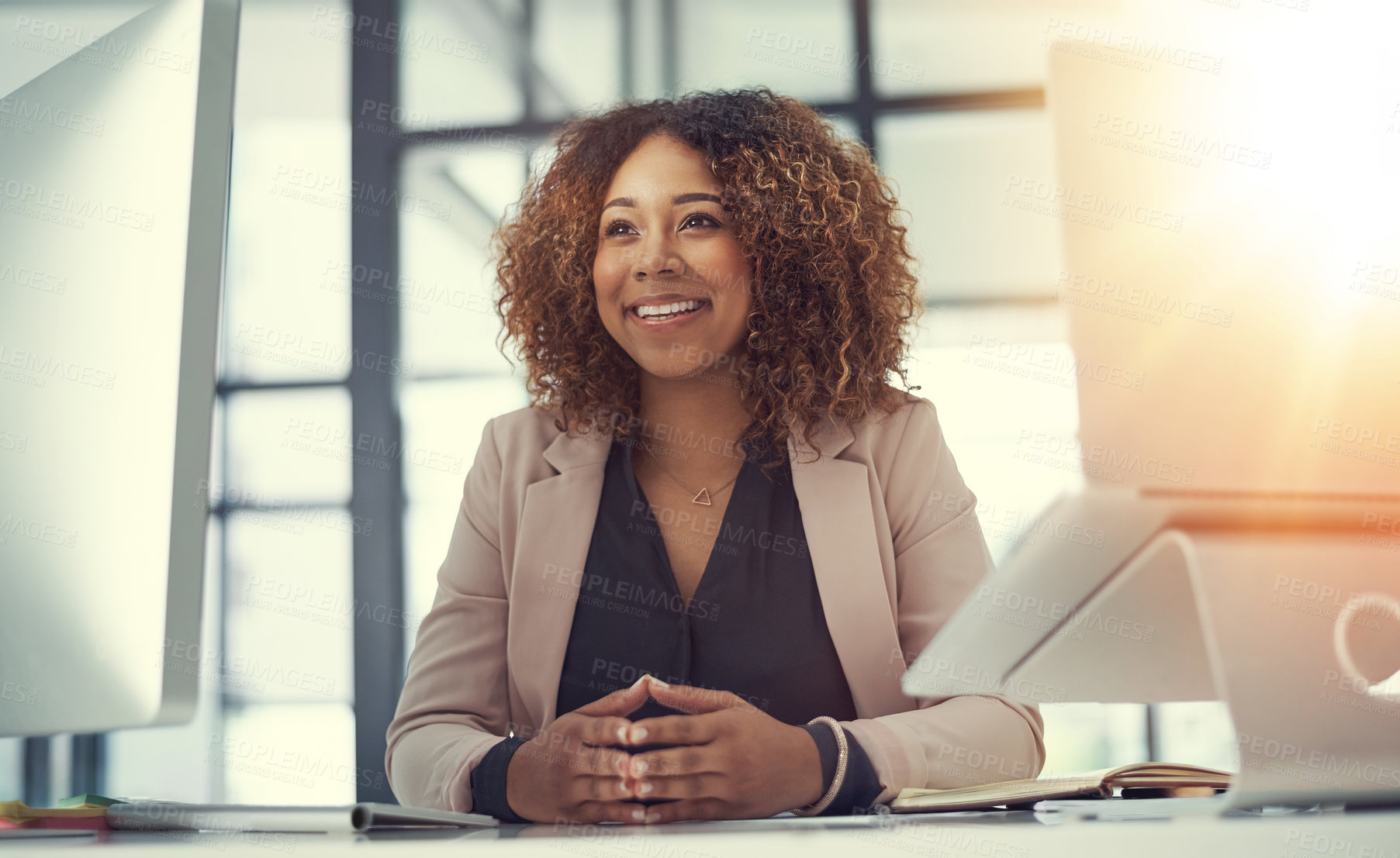 Buy stock photo Shot of a thoughtful young businesswoman working at her desk in a modern office