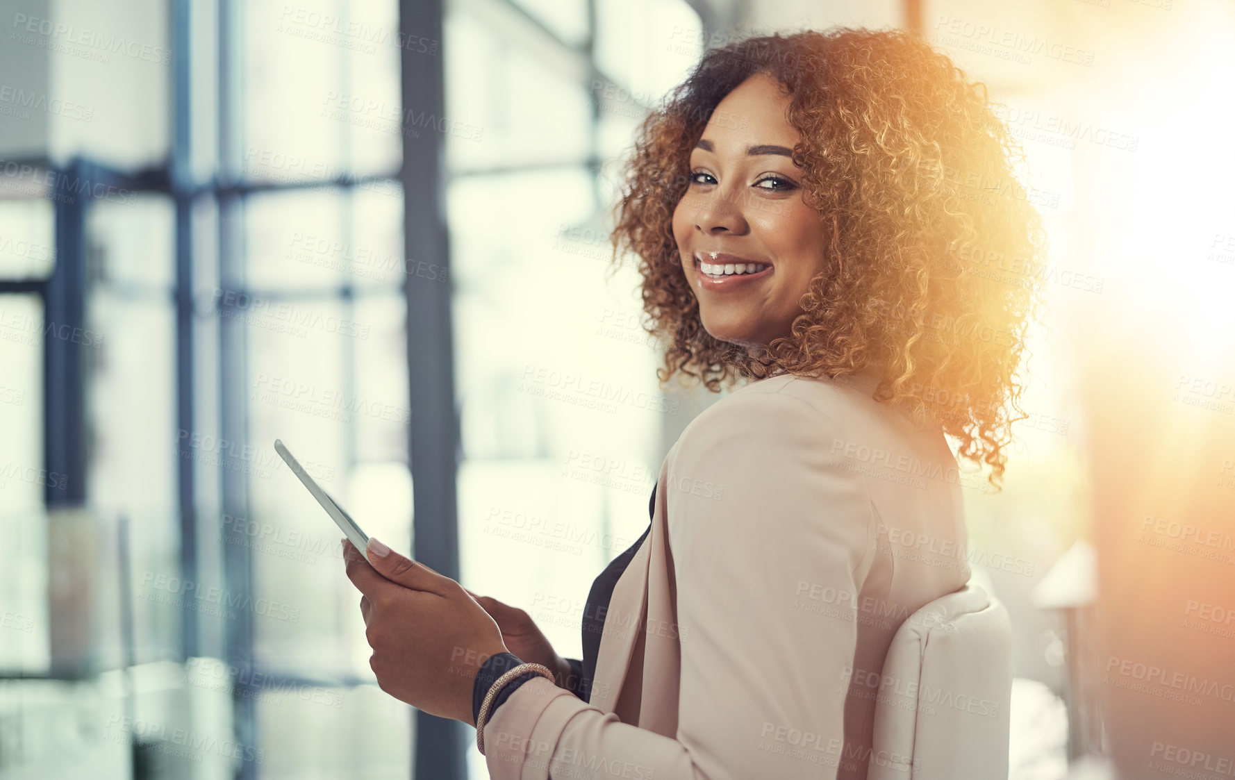 Buy stock photo Shot of a young businesswoman using a digital tablet at work