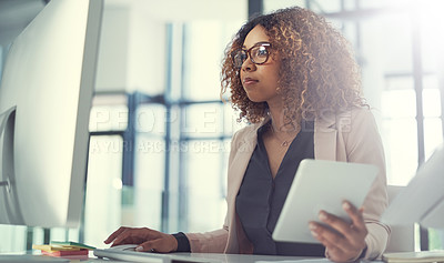 Buy stock photo Shot of a young businesswoman using a digital tablet and computer at work