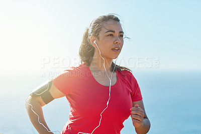 Buy stock photo Cropped shot of an attractive young woman out for a morning run