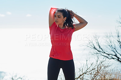 Buy stock photo Cropped shot of an attractive young woman warming up before a workout