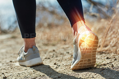 Buy stock photo Shot of an unrecognizable woman running outdoors with a highlighted ankle injury