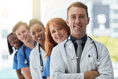 Buy stock photo Confident leader, portrait and medical group in hospital for diversity, about us or service in line. Face, happy people and healthcare team, doctors and professional nurses together with arms crossed