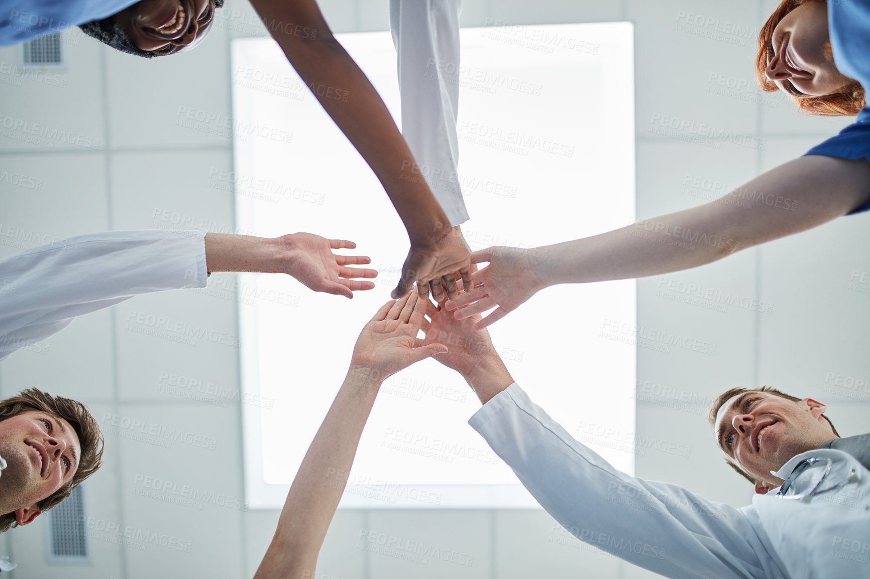 Buy stock photo People, hands together and below with medical team for unity, meeting or motivation at hospital. Low angle or closeup of group piling or touching in collaboration, solidarity or mission at clinic