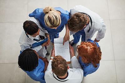 Buy stock photo Above, doctor group and paperwork in a hospital and clinic with teamwork and collaboration. Medical team, nurse and healthcare workers with research paper and meeting in a circle with document 