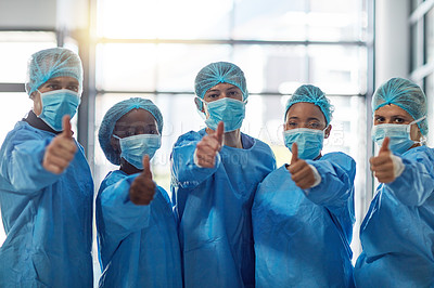 Buy stock photo Portrait of a group of medical practitioners showing thumbs up in a hospital