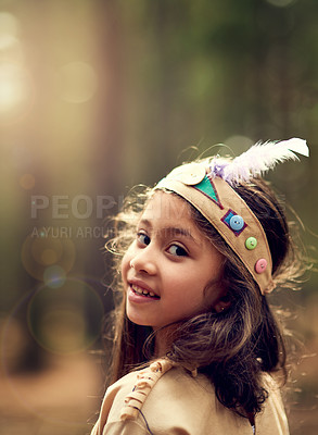 Buy stock photo Portrait, forest and child in Native American costume with nature, tradition and culture. Trees, relax and happy kid in woods with feather head gear, indigenous cosplay and outdoor childhood fun.