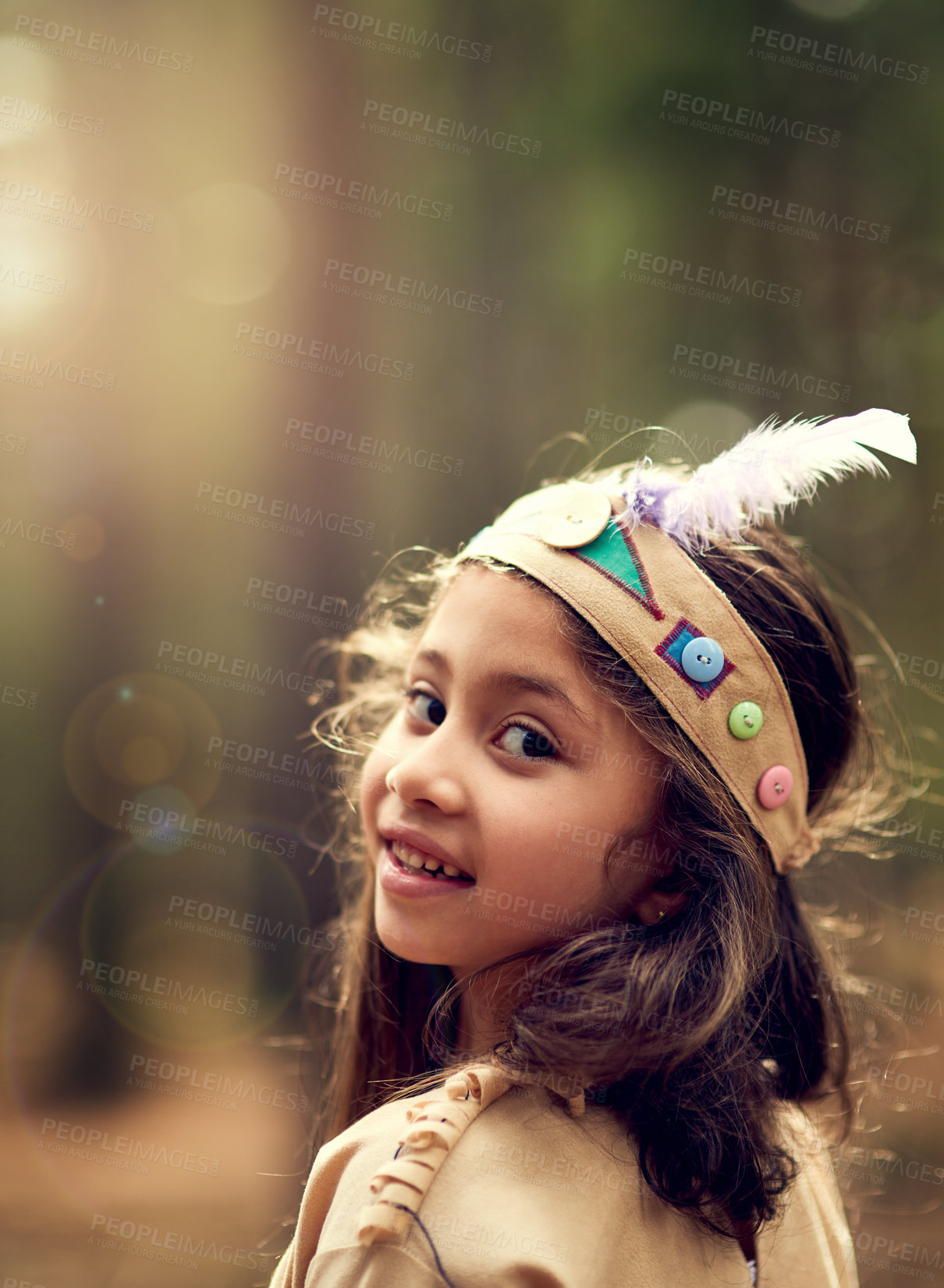 Buy stock photo Portrait, forest and child in Native American costume with nature, tradition and culture. Trees, relax and happy kid in woods with feather head gear, indigenous cosplay and outdoor childhood fun.