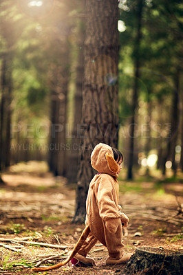 Buy stock photo Shot of a little girl walking through the forest while dressed as a bear