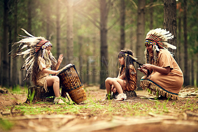 Buy stock photo Shot of a young woman and her two daughters playing dressup in the woods