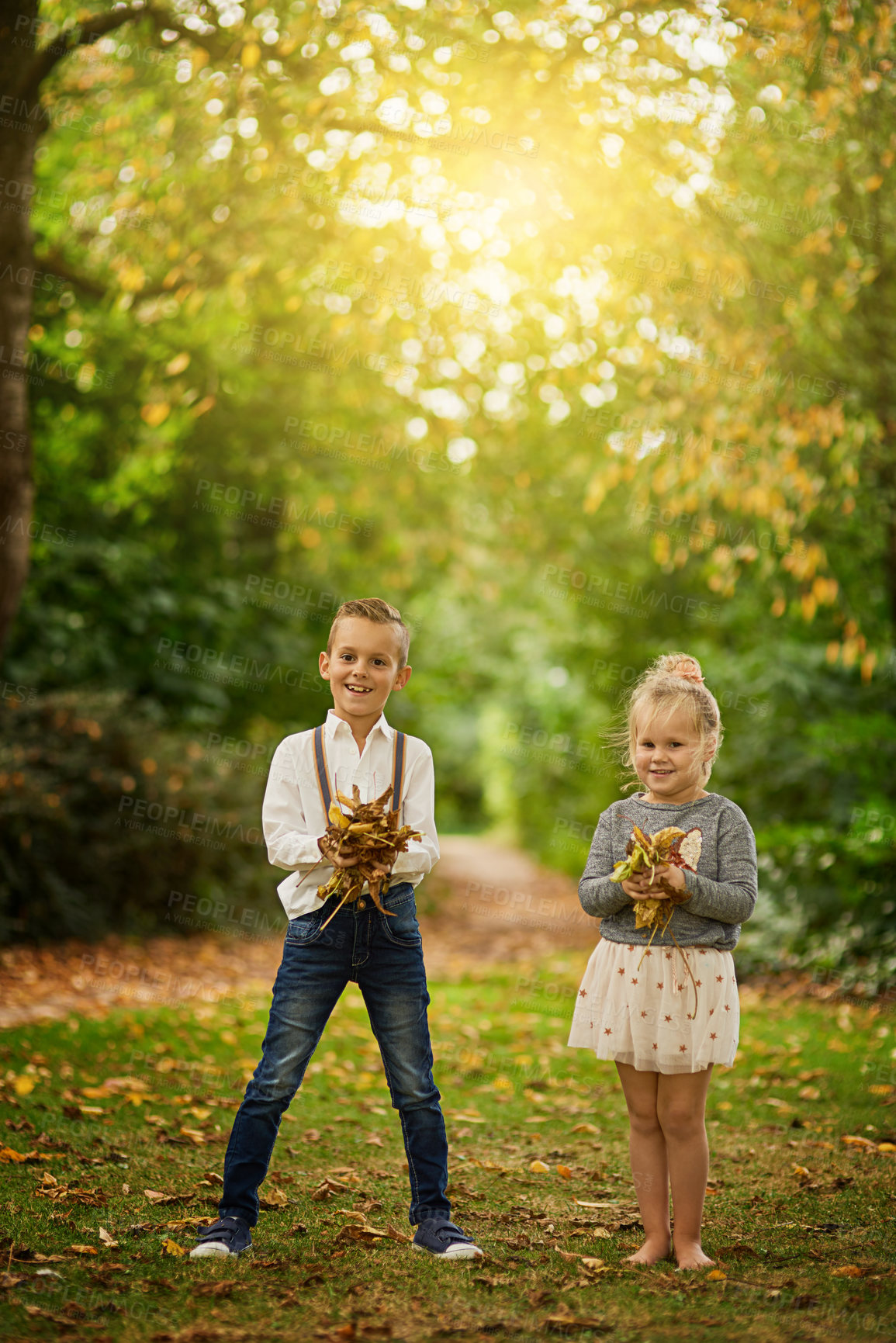 Buy stock photo Shot of a boy and his little sister  having fun outside