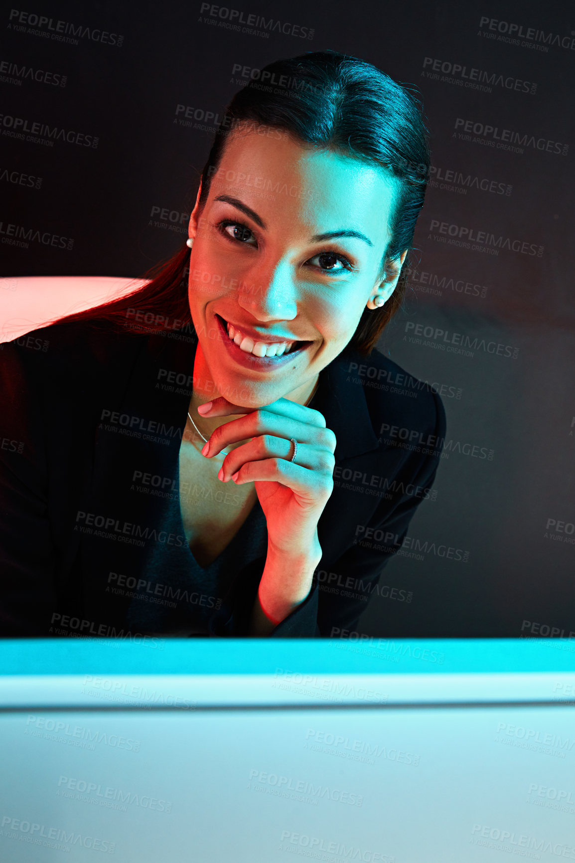 Buy stock photo Portrait of a young businesswoman posing against a dark background