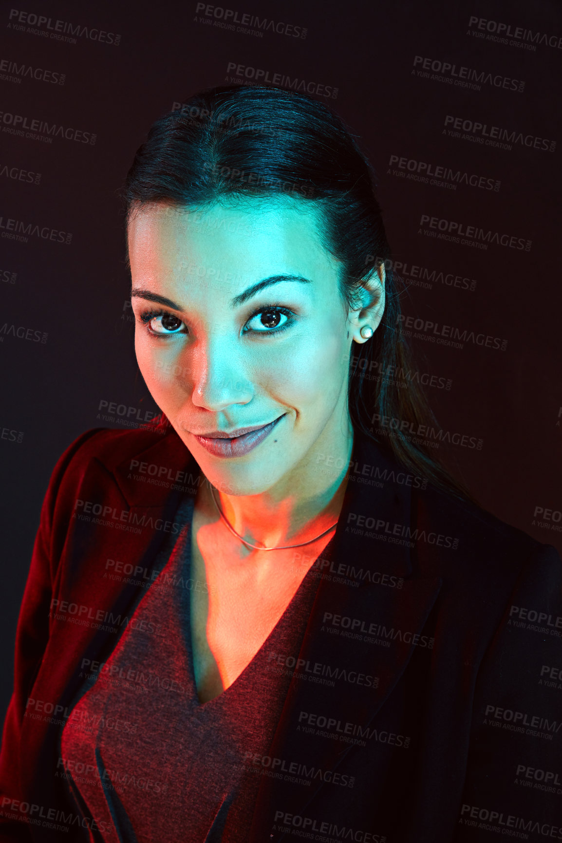 Buy stock photo Portrait of a young businesswoman posing against a dark background