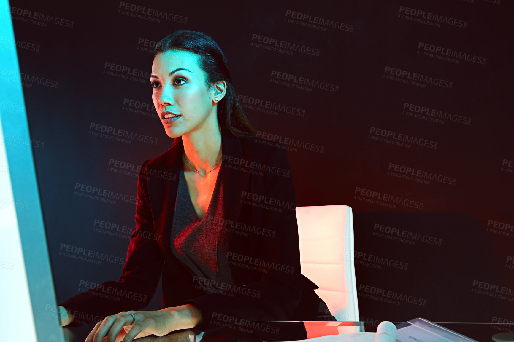 Buy stock photo Shot of a young businesswoman posing against a dark background