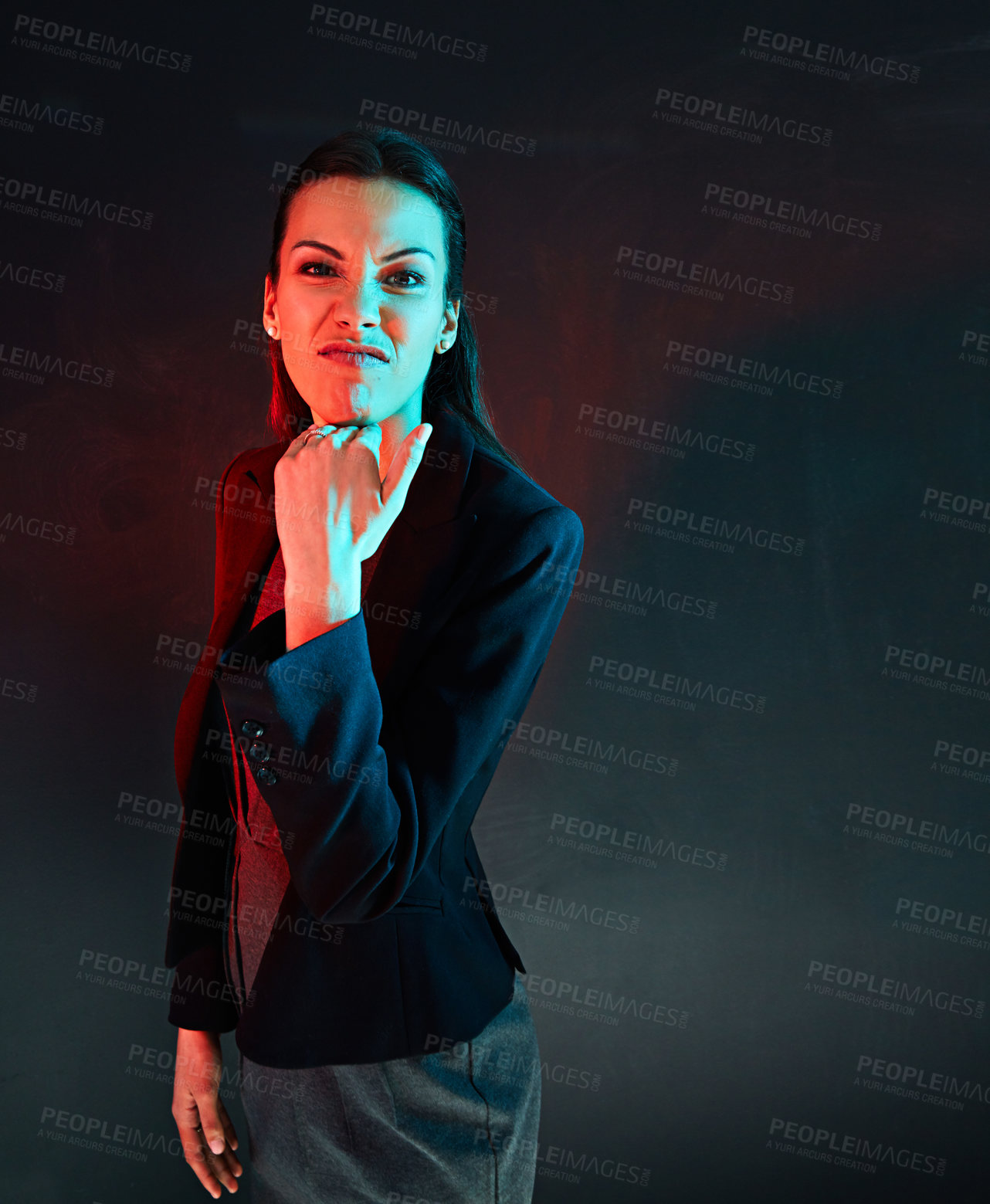 Buy stock photo Portrait of a businesswoman making a rude gesture against a dark background