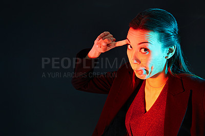 Buy stock photo Portrait of a businesswoman pulling a funny face against a dark background
