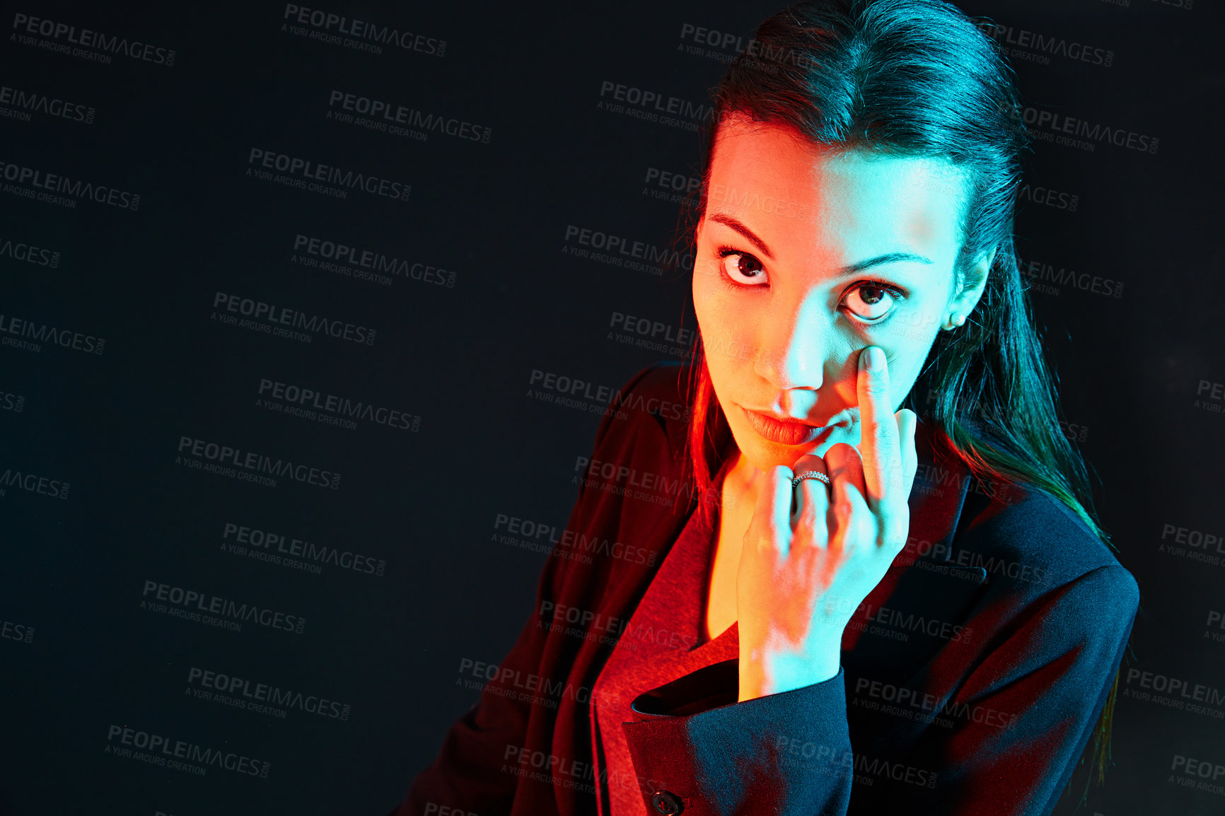 Buy stock photo Portrait of a businesswoman holding her eyelid in a rude gesture against a dark background