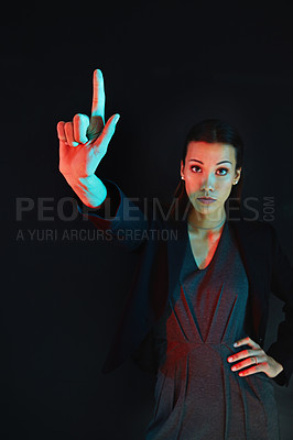 Buy stock photo Portrait of a young businesswoman showing a number with her fingers against a dark background