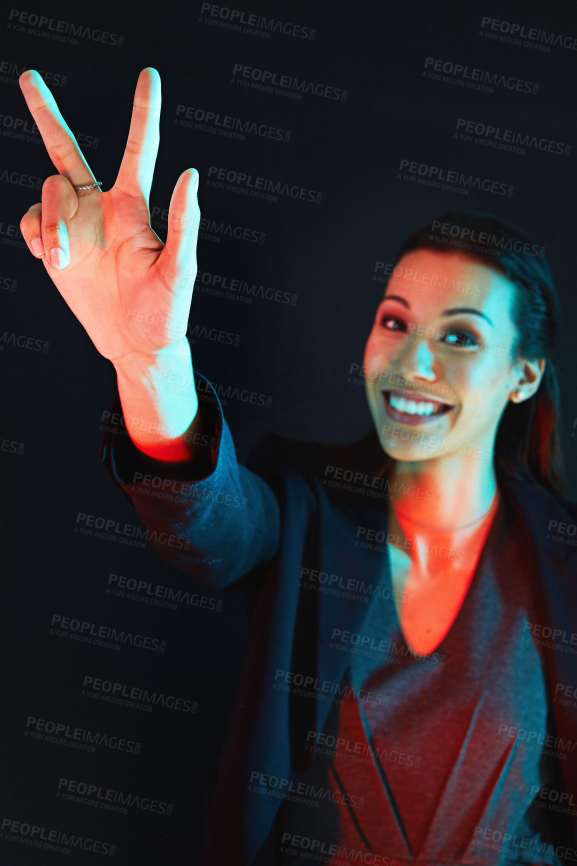 Buy stock photo Portrait of a young businesswoman showing a number with her fingers against a dark background