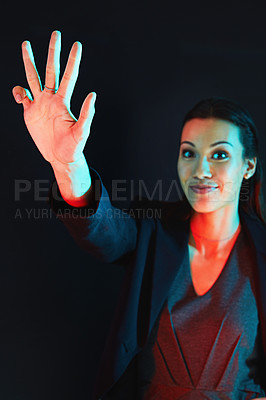 Buy stock photo Portrait of a young businesswoman showing a number with her fingers against a dark background