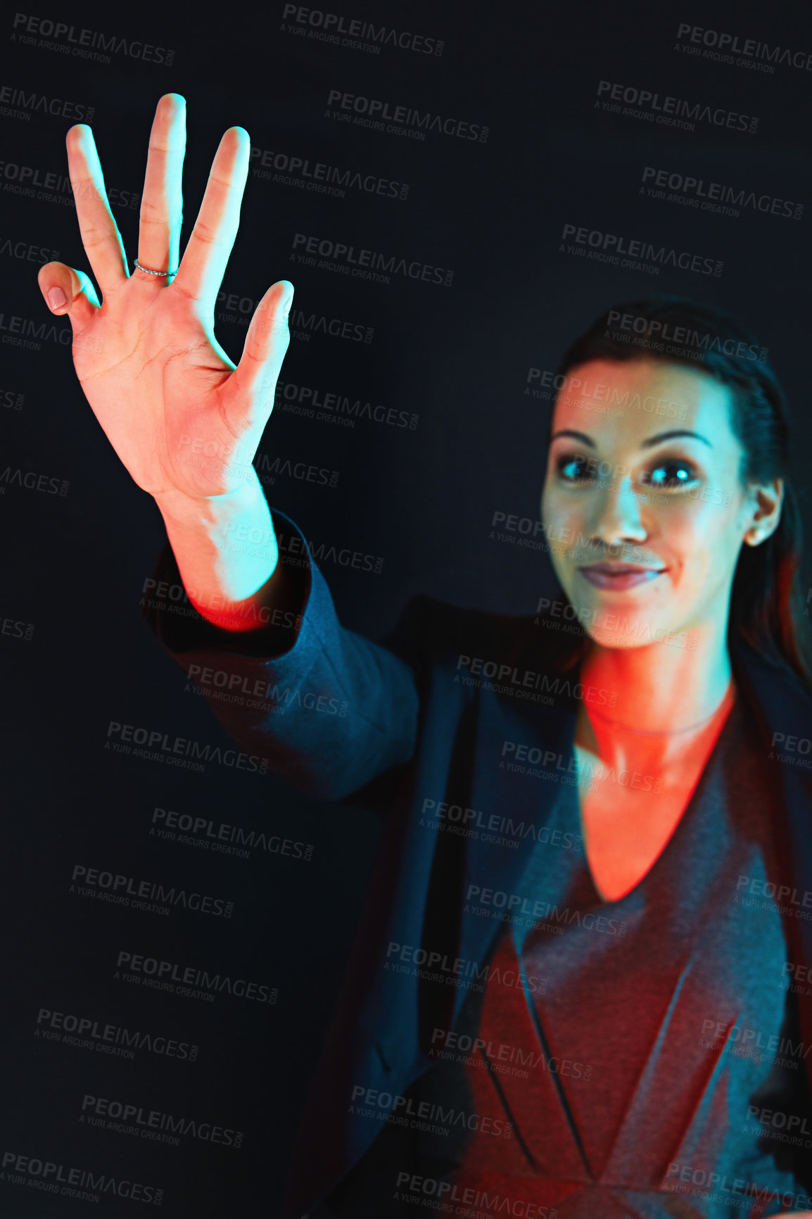 Buy stock photo Portrait of a young businesswoman showing a number with her fingers against a dark background