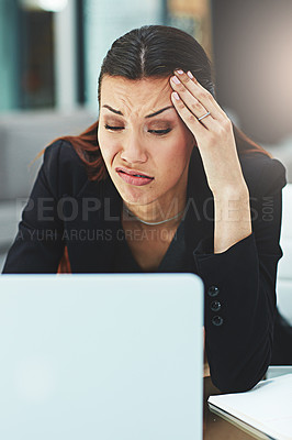 Buy stock photo Shot of an unhappy businesswoman looking at her laptop in disgust