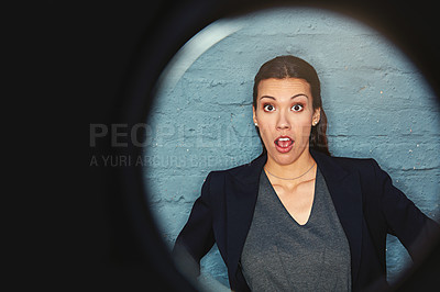 Buy stock photo Portrait of a businesswoman posing against a brick wall with a peephole effect