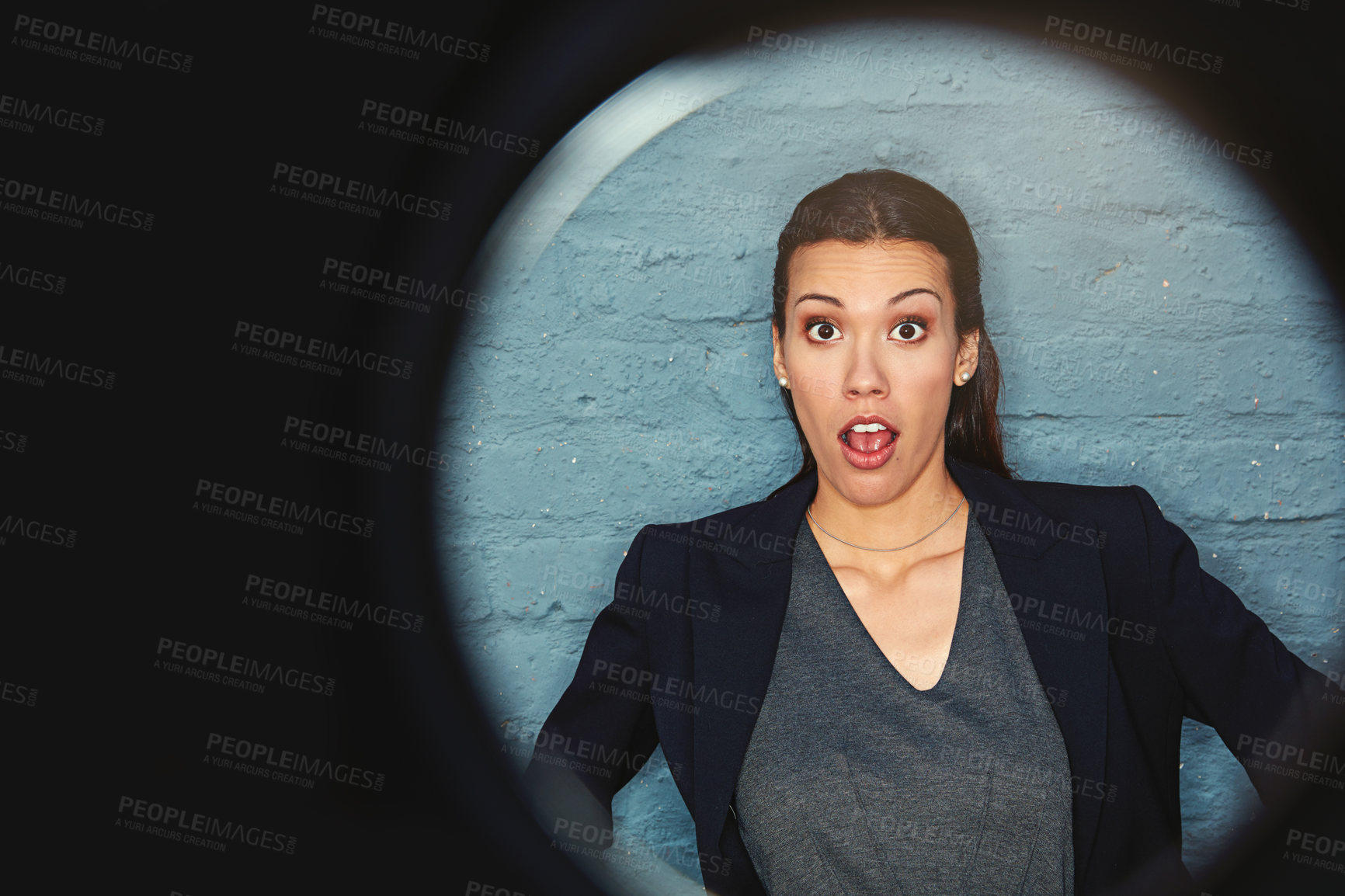 Buy stock photo Portrait of a businesswoman posing against a brick wall with a peephole effect