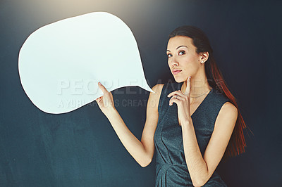 Buy stock photo Portrait of a young woman posing with a speech bubble against a gray background