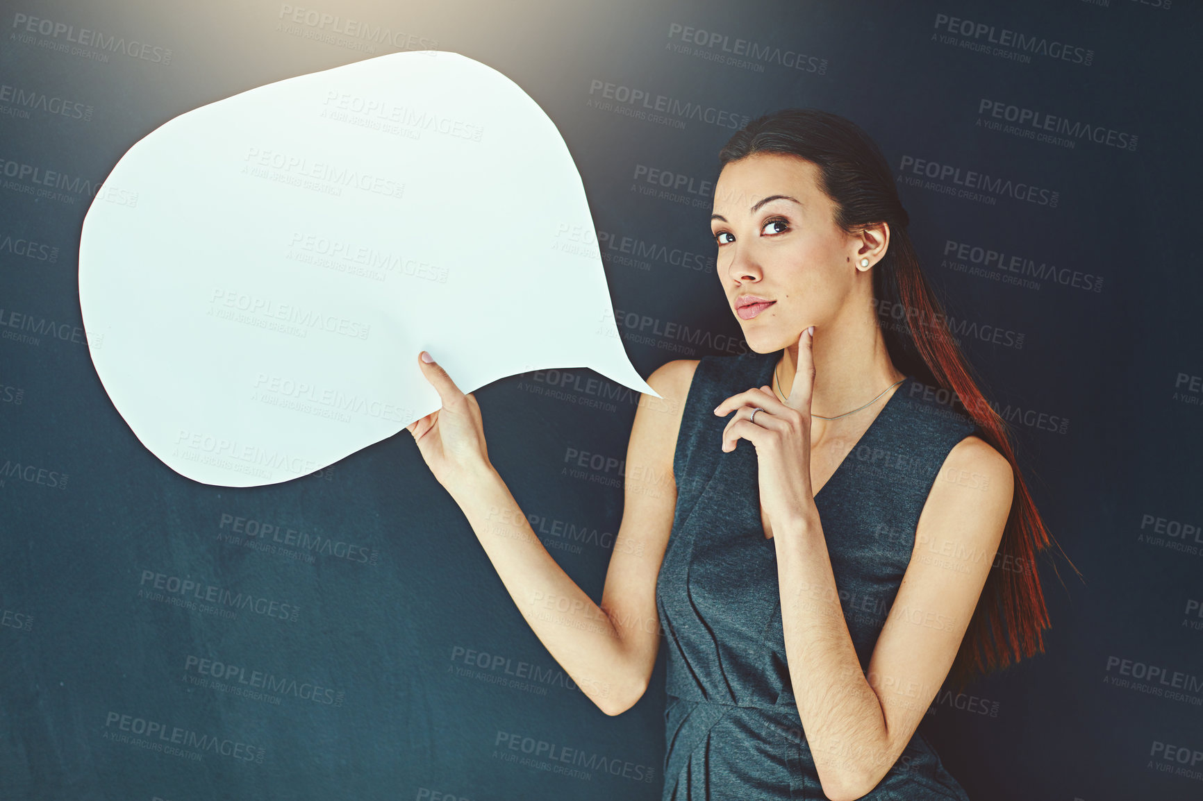 Buy stock photo Portrait of a young woman posing with a speech bubble against a gray background