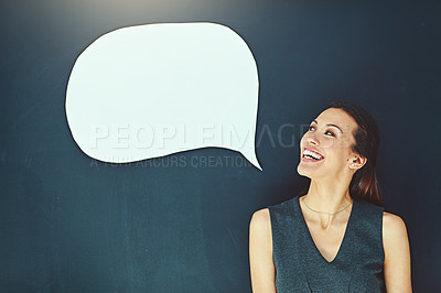 Buy stock photo Shot of a young woman posing with a speech bubble against a gray background