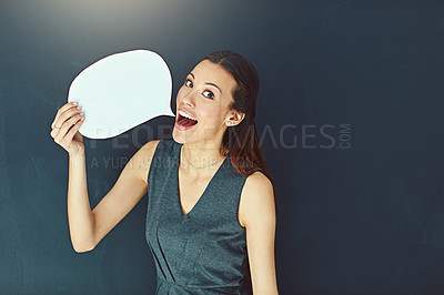 Buy stock photo Portrait of a young woman posing with a speech bubble against a gray background