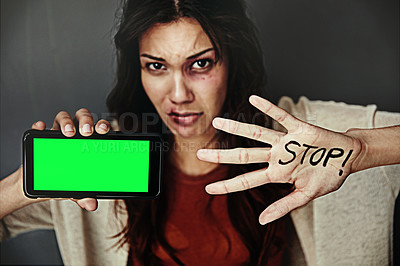 Buy stock photo Portrait of a bruised young woman holding a cellphone and the word 