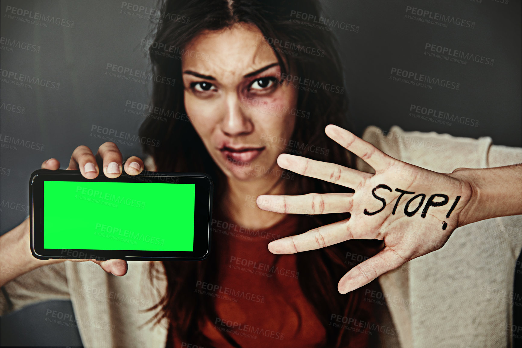 Buy stock photo Portrait of a bruised young woman holding a cellphone and the word 