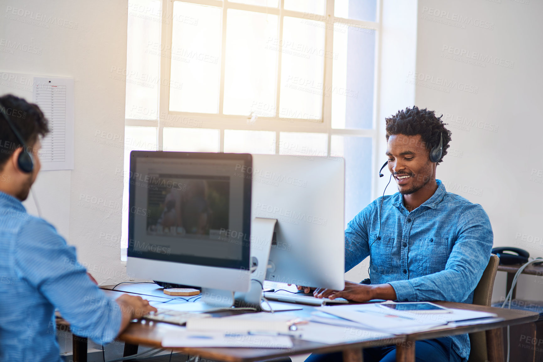 Buy stock photo Telemarketing, customer service and men with computers, talking and conversation for help, advice and friendly. Male coworkers, happy operator and consultants with headset, happiness and call center