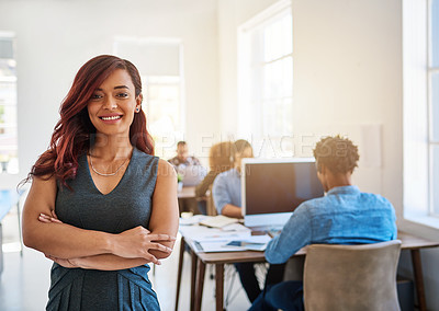 Buy stock photo Portrait of a confident young woman working a modern office with her team in the background
