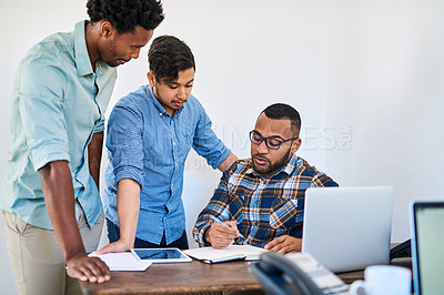 Buy stock photo Shot of a team of young entrepreneurs having a discussion in a modern office