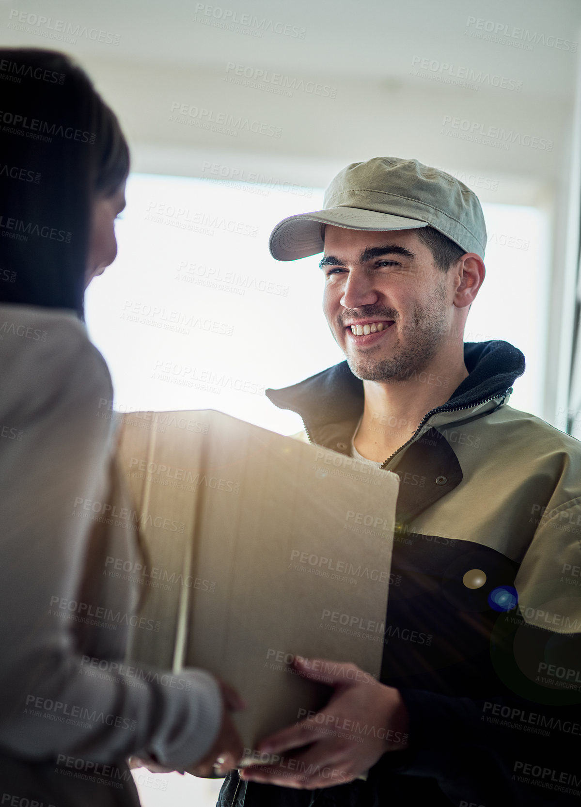 Buy stock photo Cropped shot of a courier making a delivery to a customer at her home