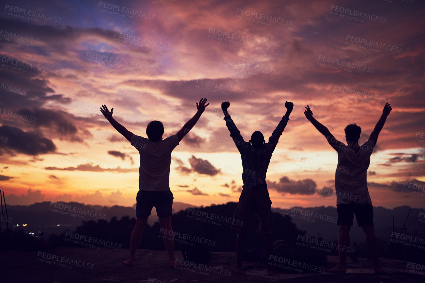 Buy stock photo Rear view shot of a group of people standing outside with their arms outstretched