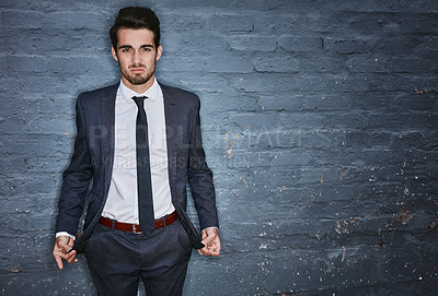 Buy stock photo Shot of a businessman pulling out his empty pockets