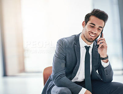 Buy stock photo Shot of a trendy young businessman talking on his cellphone in the office