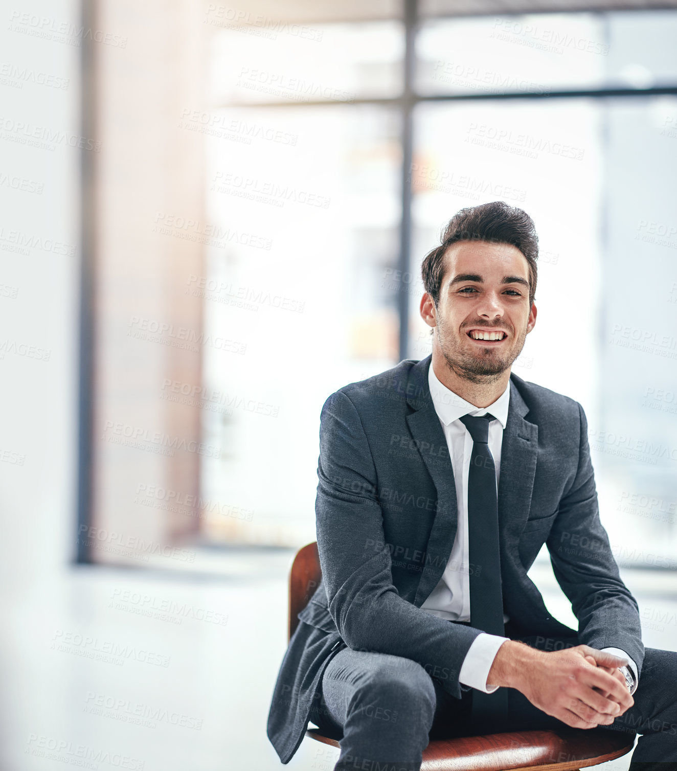 Buy stock photo Portrait of a happy young businessman posing in the office
