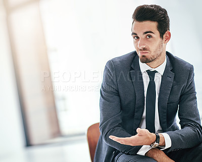 Buy stock photo Portrait of a trendy young businessman indicating copyspace next to him in the office