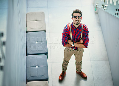 Buy stock photo Portrait of a handsome young designer standing with his arms folded in the office