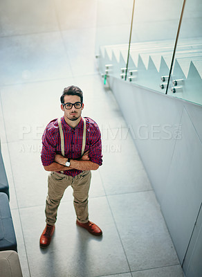 Buy stock photo Portrait of a handsome young designer standing with his arms folded in the office