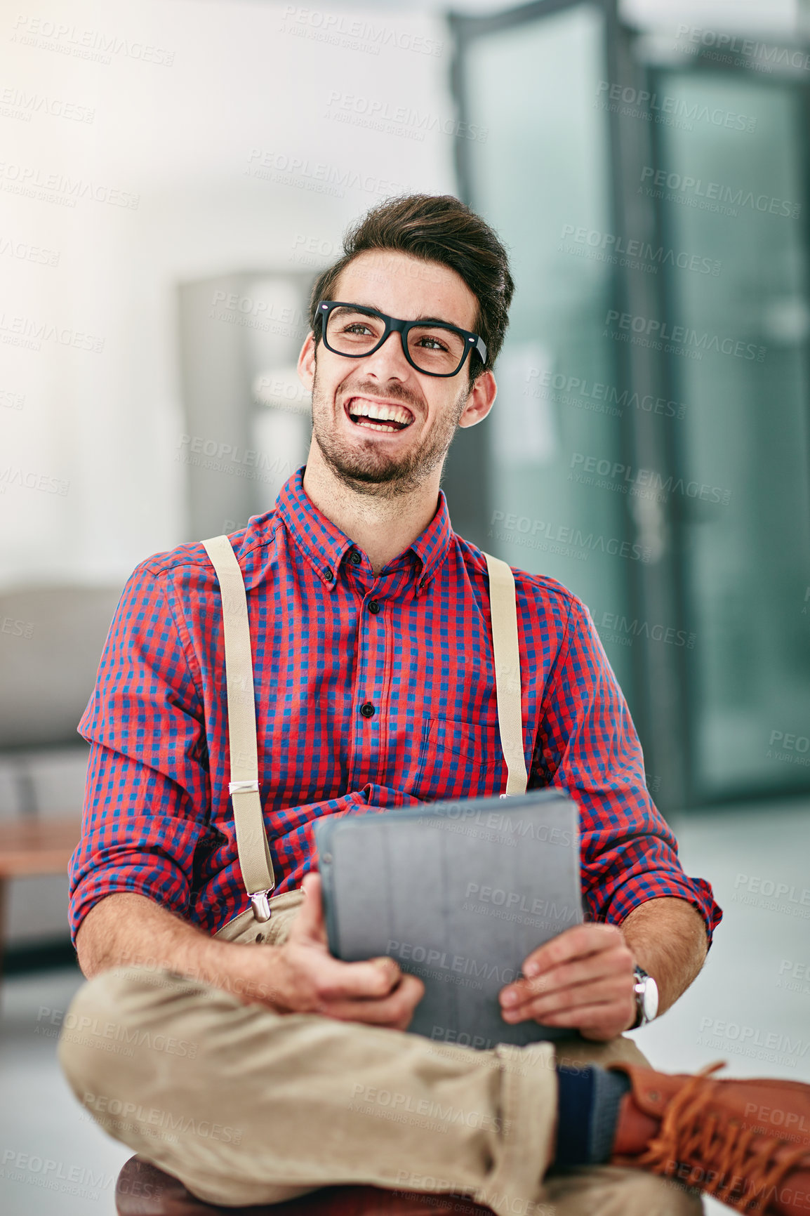 Buy stock photo Cropped shot of a handsome young designer using a digital tablet in his office